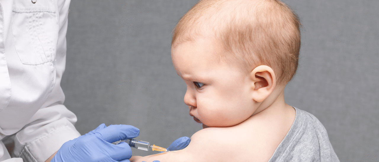 Child receiving vaccination from pediatric doctor in hospital
