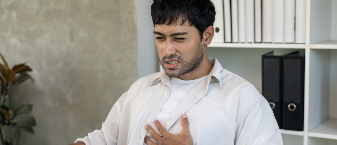 Person experiencing chest burning sensation due to acidity