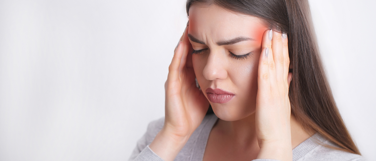 Woman suffering from migraine headache